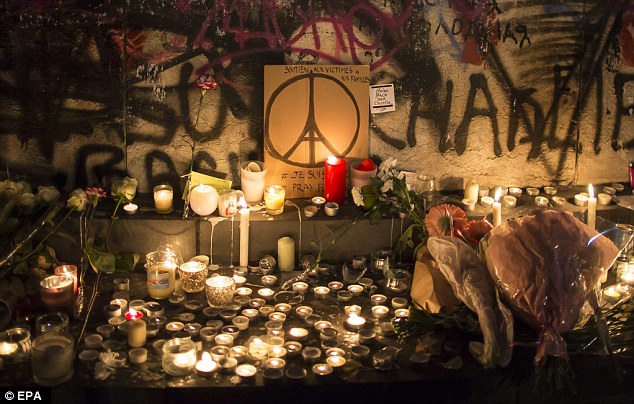 2E71A9FC00000578-3319566-Lit_up_People_place_flowers_and_light_candles_in_tribute_for_the-a-54_1447617798576