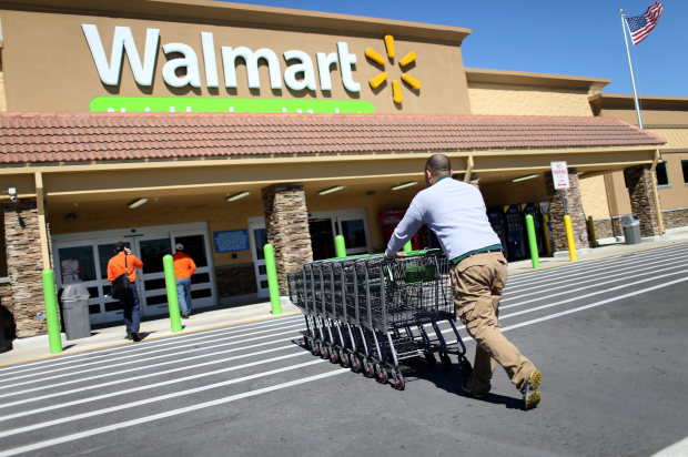 MIAMI, FL - FEBRUARY 19: Walmart employee Yurdin Velazquez pushes grocery carts at a Walmart store on February 19, 2015 in Miami, Florida. The Walmart company announced Thursday that it will raise the wages of its store employees to $10 per hour by next February, bringing pay hikes to an estimated 500,000 workers. (Photo by Joe Raedle/Getty Images)
