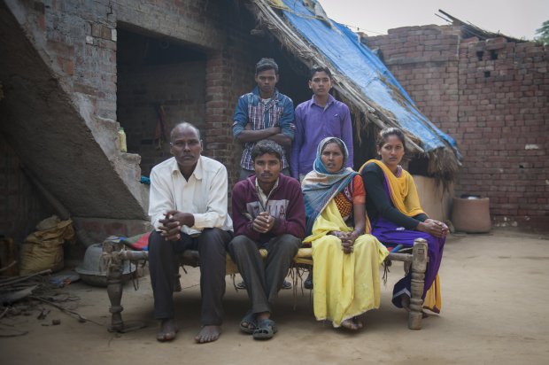 *** EXCLUSIVE - VIDEO AVAILABLE *** FARRUKHABAD, INDIA - DECEMBER 09: Arun Kumar Rajput sits with his father Sri Ram Singh, 55 years (left), mother Kokla Devi , 50 years (right), his sister Aarti (extreme right) and his two brothers Lal Bahadur (back left) and Sudeer Rajput (back right) at his house on December 09, 2015 in Farrukhabad, India. A YOUNG man with FOUR legs appealed to doctors to amputate his two extra limbs. Arun Kumar, 22, was born with two extra legs growing from his lower back - one underdeveloped and the other permanently bent at the knee. After living for 15 years without any kind of treatment, Arun, from Uttar Pradesh, India, appealed through social media for medical help to remove his extra legs. A team of specialists at Fortis Hospital in Delhi responded to ArunÃ­s plea for help and organised a series of tests to find out how the legs are attached and if he can be treated. **CONDITION OF USAGE: The following plug must be used in print and/or online: Arun's story appears in Body Bizarre, Thursday November 3, 10pm, on TLCÃ® credit: TLC/ Barcroft Productions** PHOTOGRAPH BY Arkaprava Ghosh / Barcroft Images London-T:+44 207 033 1031 E:hello@barcroftmedia.com New York-T:+1 212 796 2458 E:hello@barcroftusa.com New Delhi-T:+91 11 4053 2429 E:hello@barcroftindia.com www.barcroftimages.com